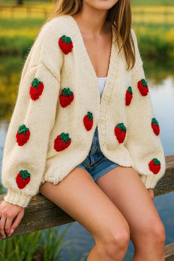 Cream hand-knit cardigan with crocheted strawberries